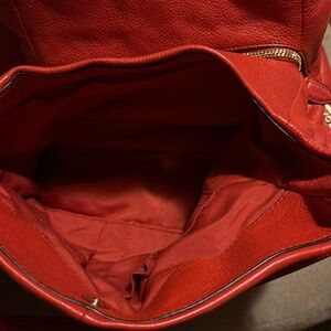 This is a coral coach bag with multiple compartments for great organization!